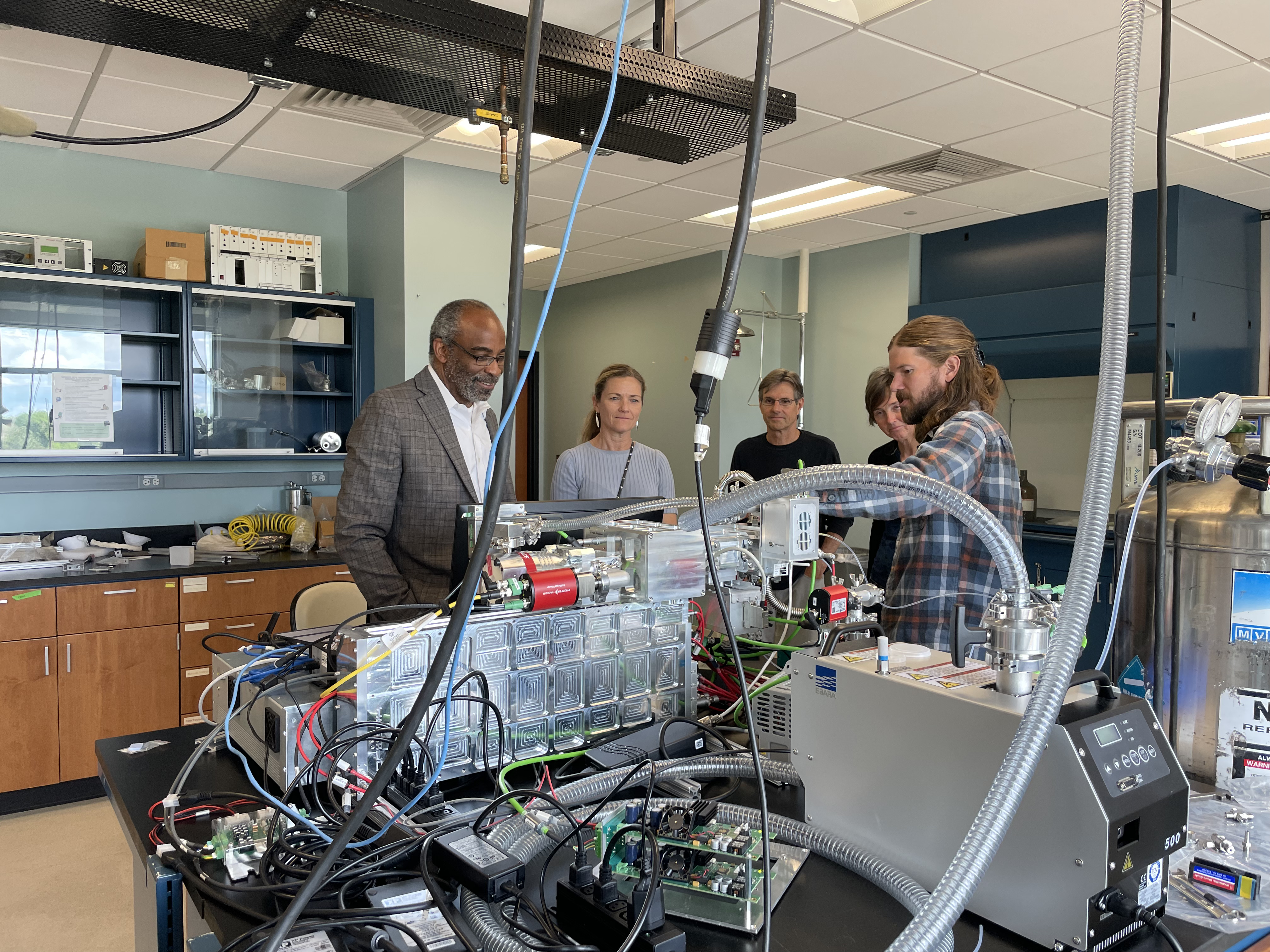 Brett Palm explains the CIMS instrument while and NCAR Director Everette Joseph and NSF Atmospheric and Geospace Sciences (AGS) division director Anne Johansen look on.