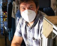 NCAR scientist Alessandro Franchin sits in front of the NCAR NOxy instrument prior to an ACCLIP test flight. (Rebecca Hornbrook)