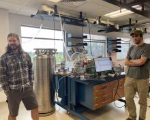 Brett Palm and Kyle Zarzana in front of the CIMS instrument.